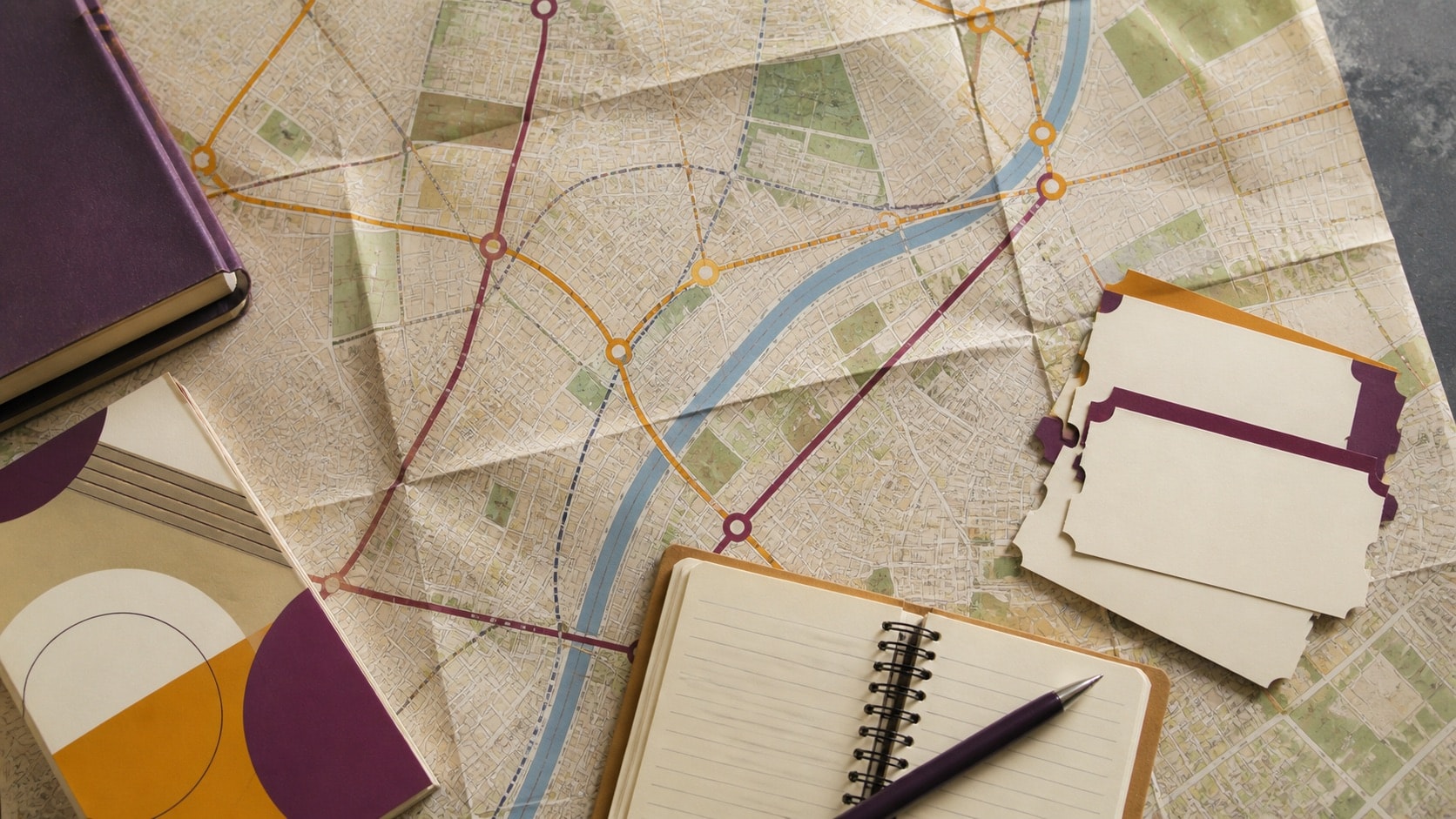 Unlabeled city map and blank guide materials suggesting a historical visitor itinerary